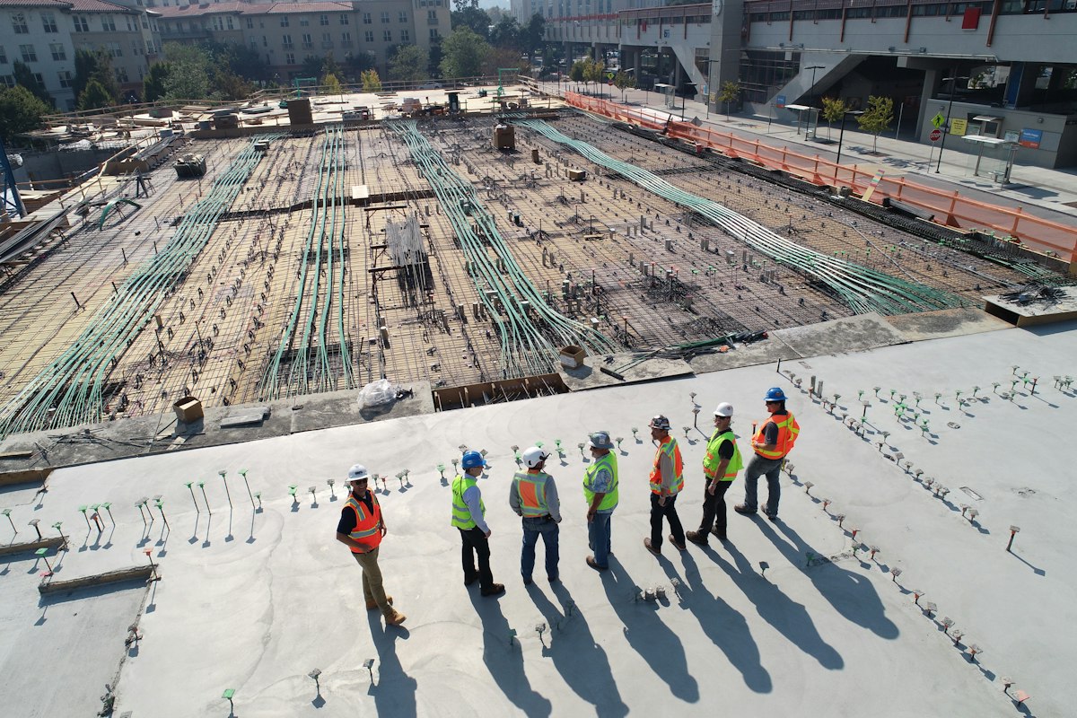 An aerial view of a construction site with engineers reviewing the site
